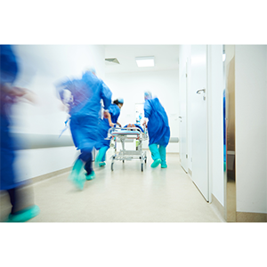 blur images of doctors and nurses in scrubs rushing a patient on a gurney for emergency alert